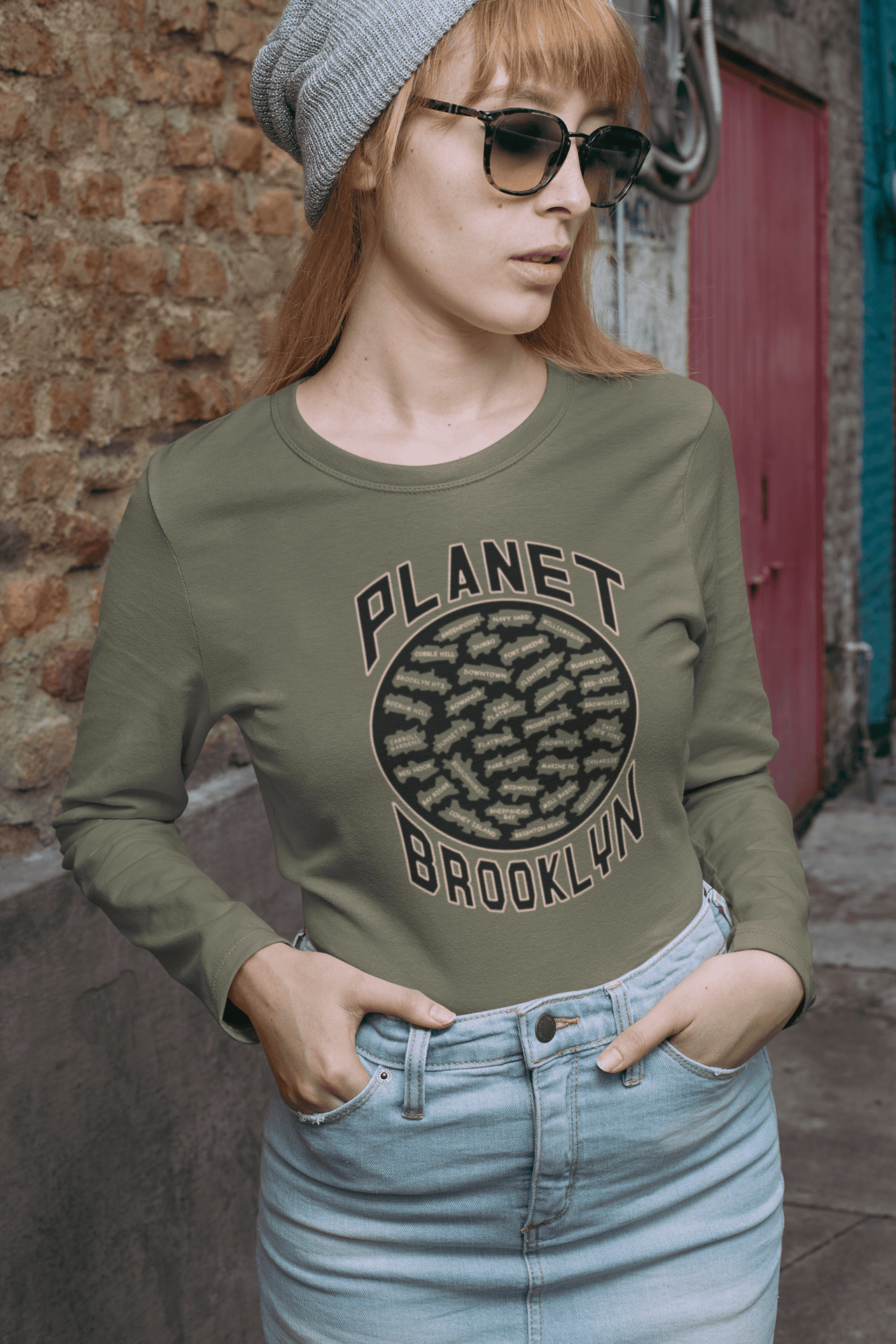 Planet-Brooklyn-MG-long-sleeve-shirt-red-haired-woman-in-a-denim-skirt.png Planet Brooklyn Long Sleeve - Image 1