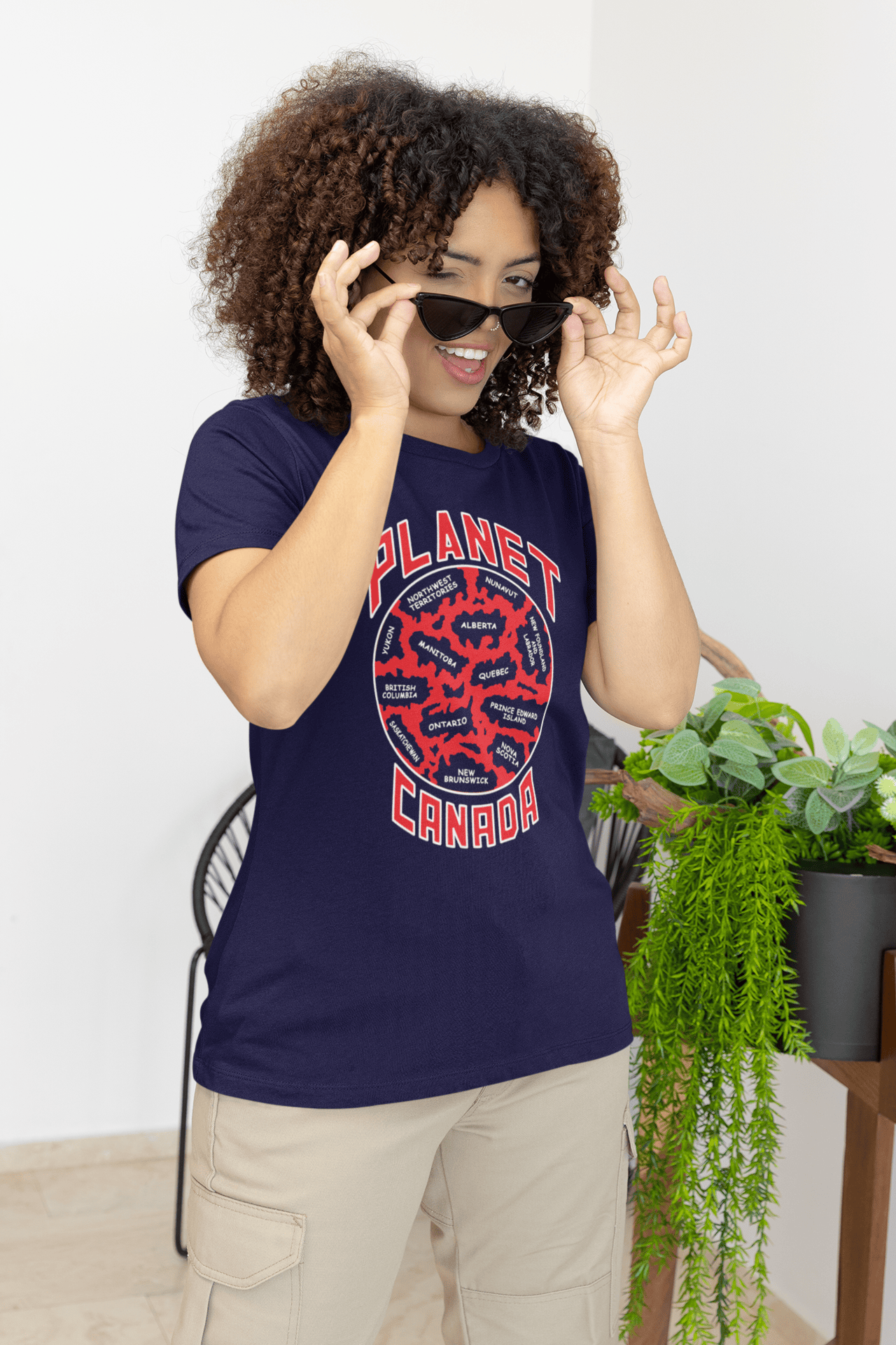 Planet-Canada-Navy-blue-SS-shirt-woman-taking-off-her-sunglasses.png Planet Canada Short Sleeve - Image 1