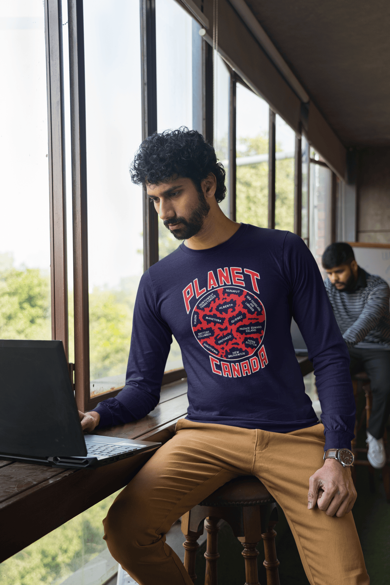 Planet-Canada-Navy-blue-long-sleeve-shirt-man-working-by-window.png Planet Canada Long Sleeve - Image 1