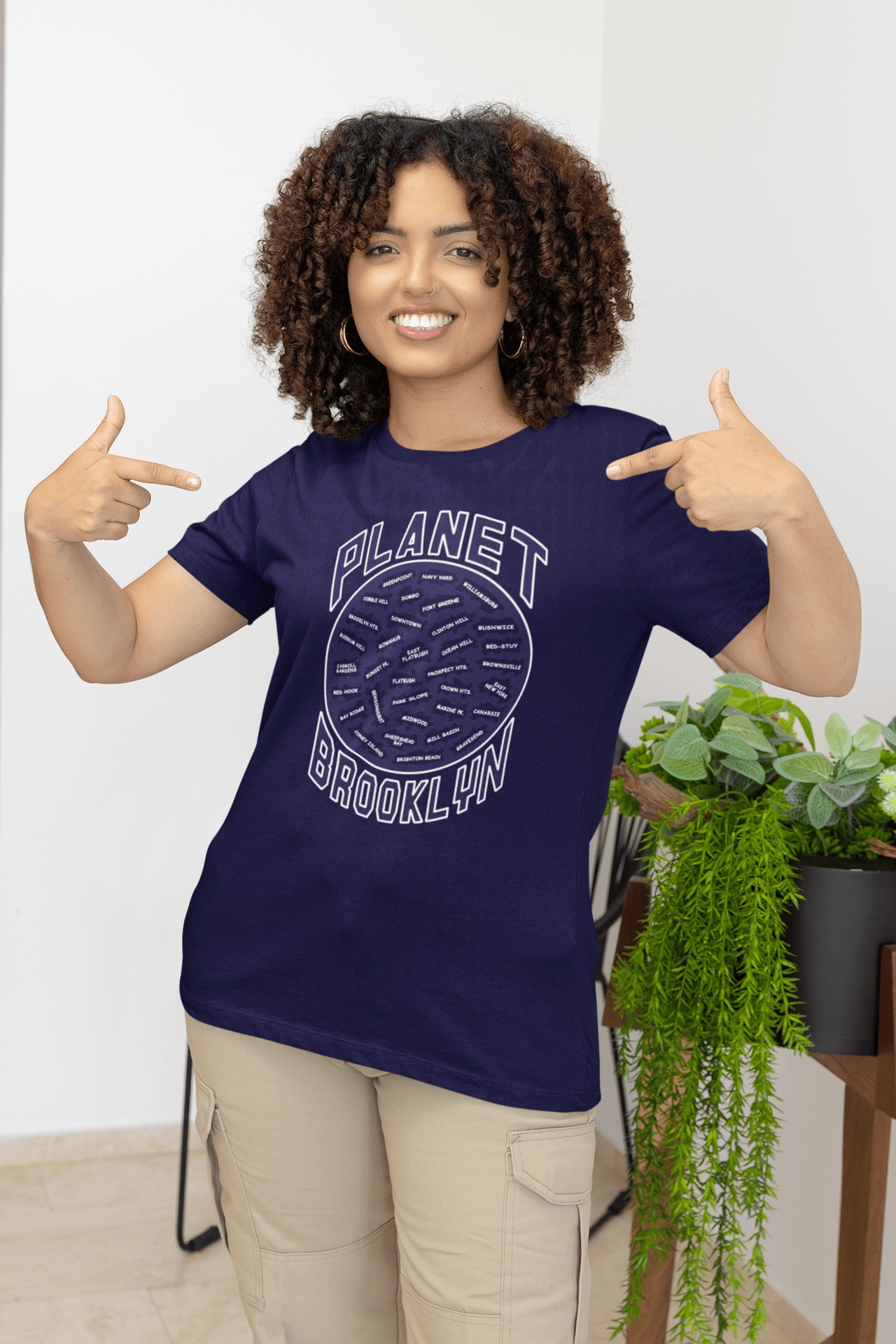 Planet-Brooklyn-Navy-blue-SS-shirt-woman-pointing-at-her-shirt Planet Brooklyn Short Sleeve - Image 1